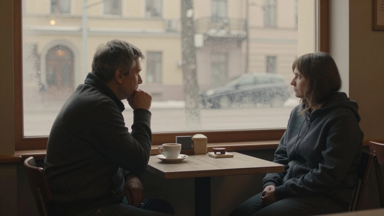 A man sits alone in a café at dawn; a woman watches him from outside the window, both isolated yet connected by quiet longing.